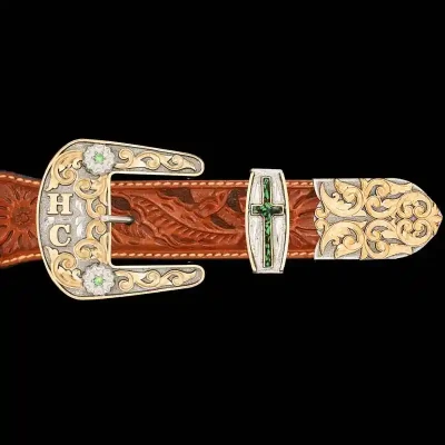 A custom western three piece belt buckle set featuring bronze scrollwork 
